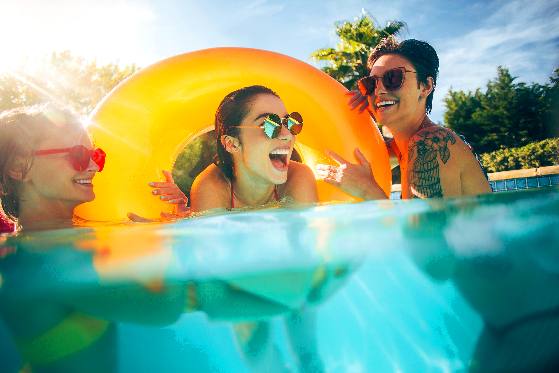 Young adults friends enjoying Summertime Fibreglass Pool